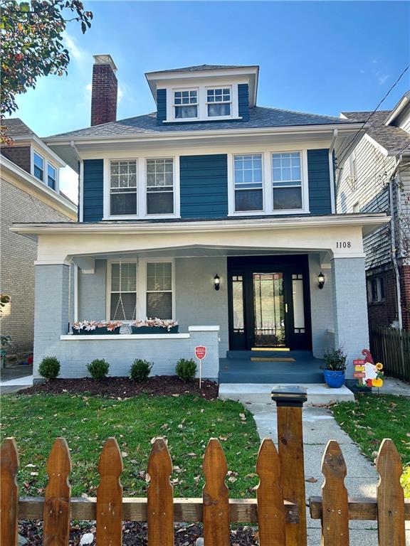 a front view of house with yard and outdoor seating