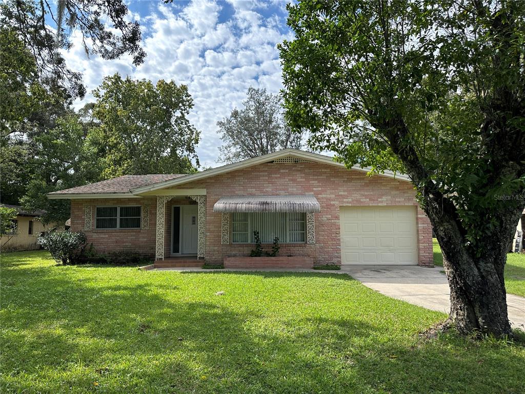 a front view of house with yard and green space