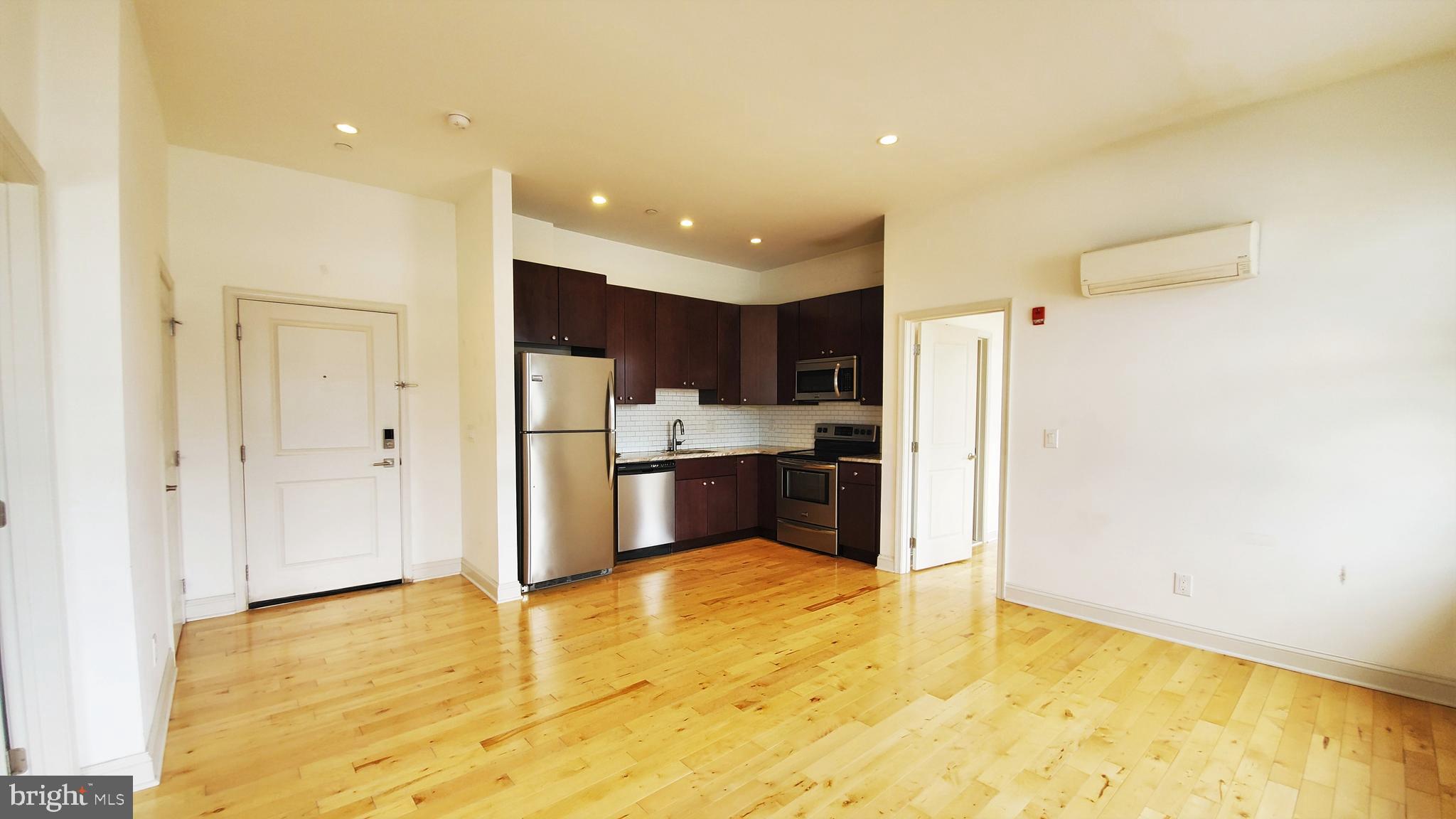 a view of kitchen with stainless steel appliances a refrigerator and a stove top oven