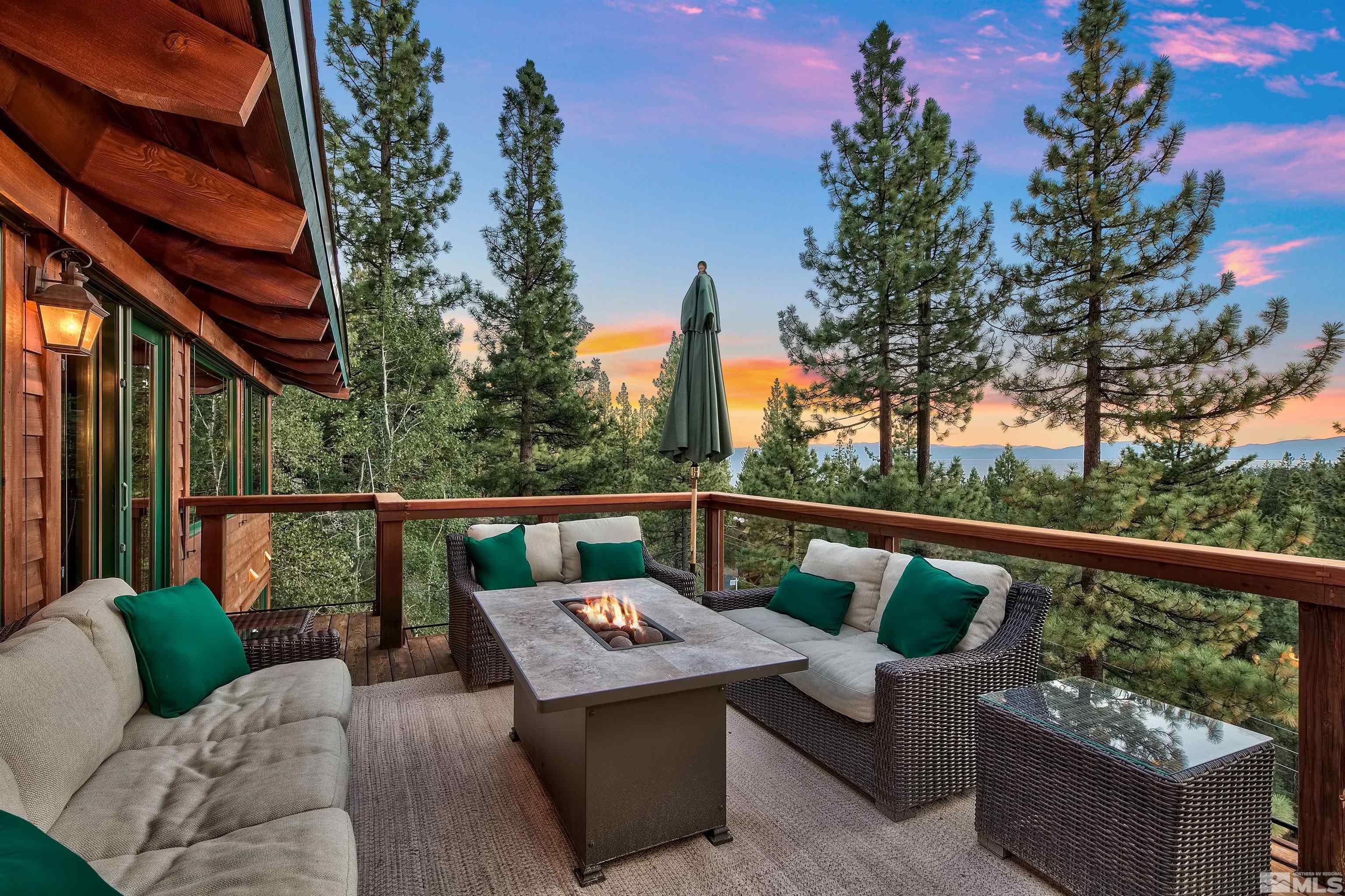 a view of a patio with couches chairs and wooden fence