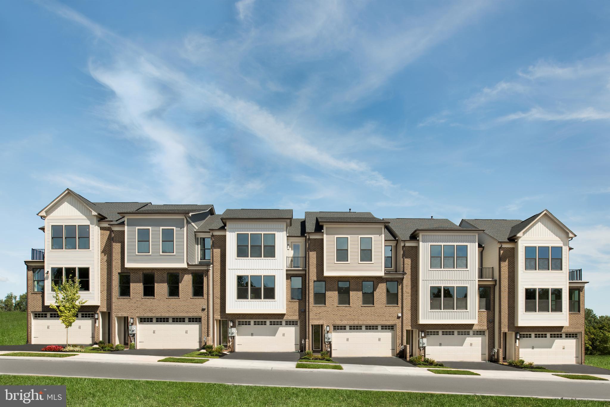 a front view of a residential apartment building with a yard