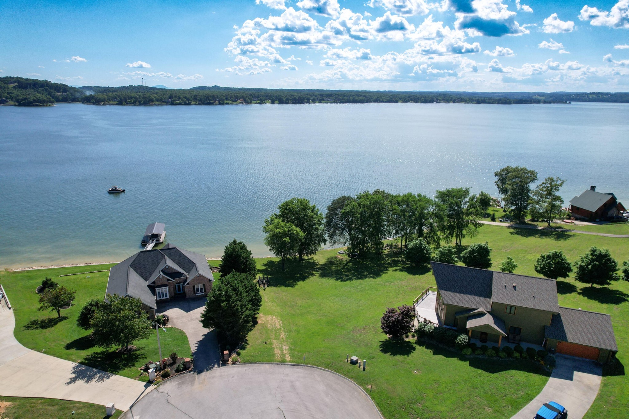 an aerial view of a house with a yard lake view and mountain view