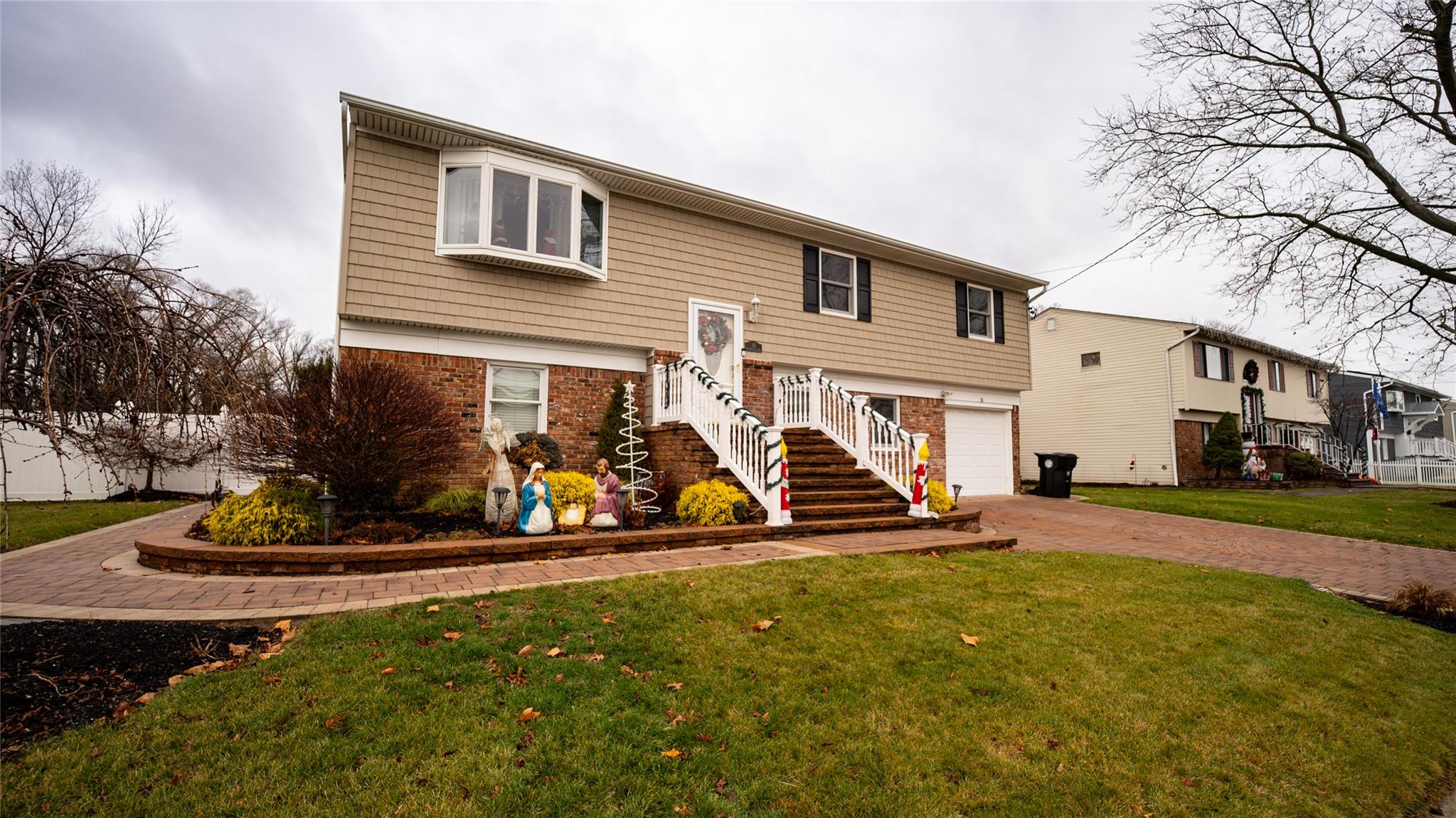 a view of a house with a yard and sitting area