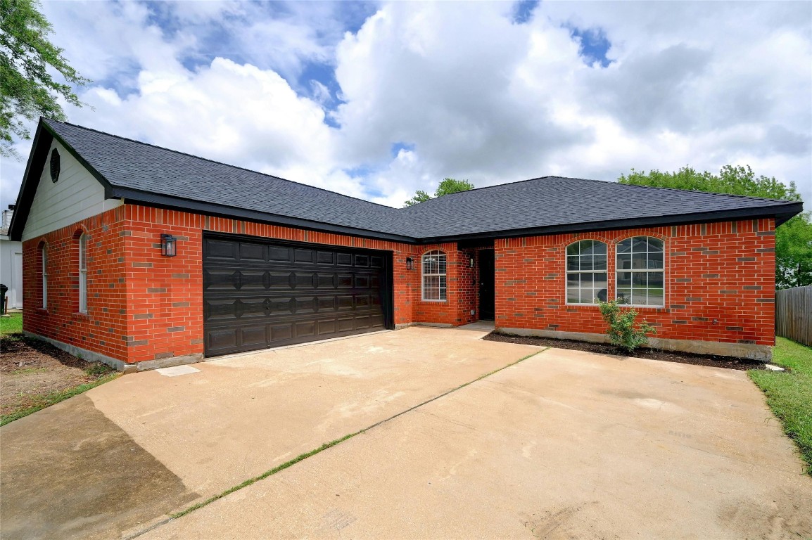 a view of house with garage and yard