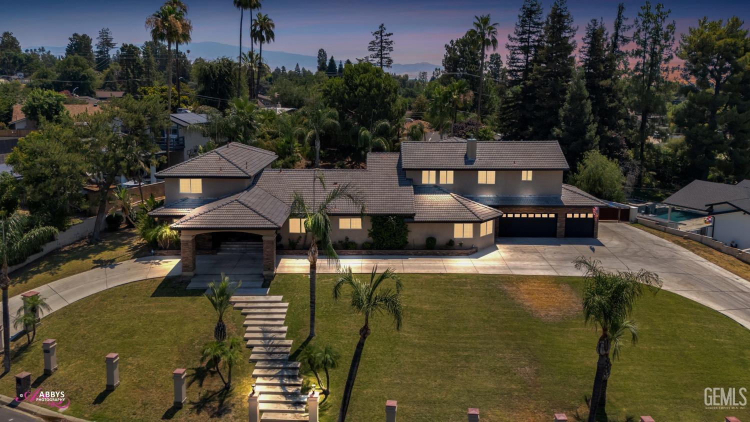 an aerial view of a house with swimming pool garden and mountain view