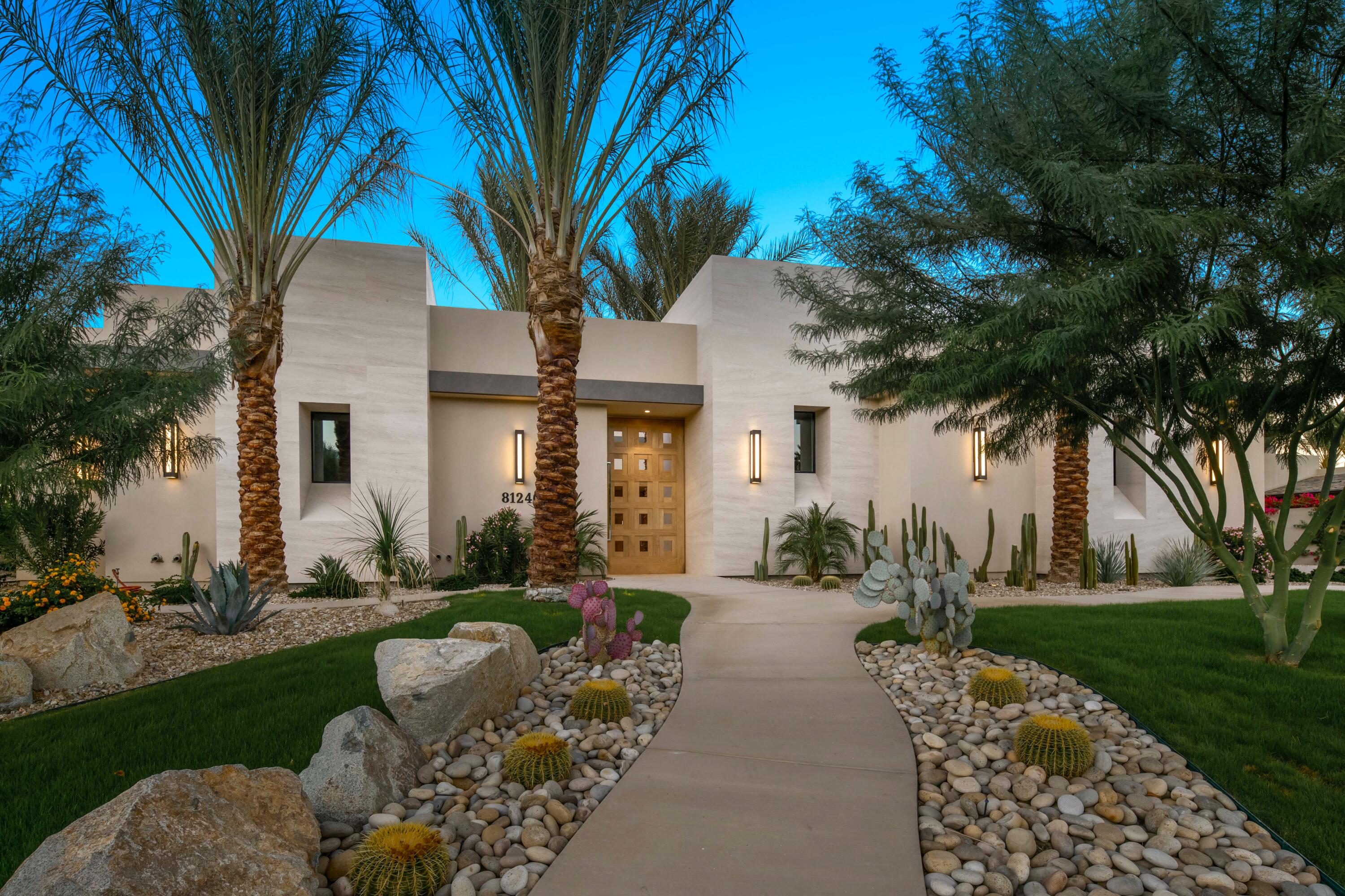 a front view of a house with yard and green space