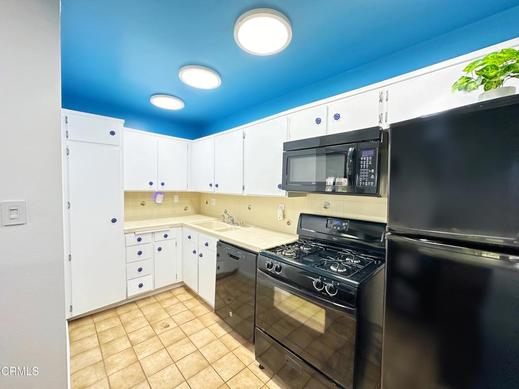 a kitchen with cabinets and appliances