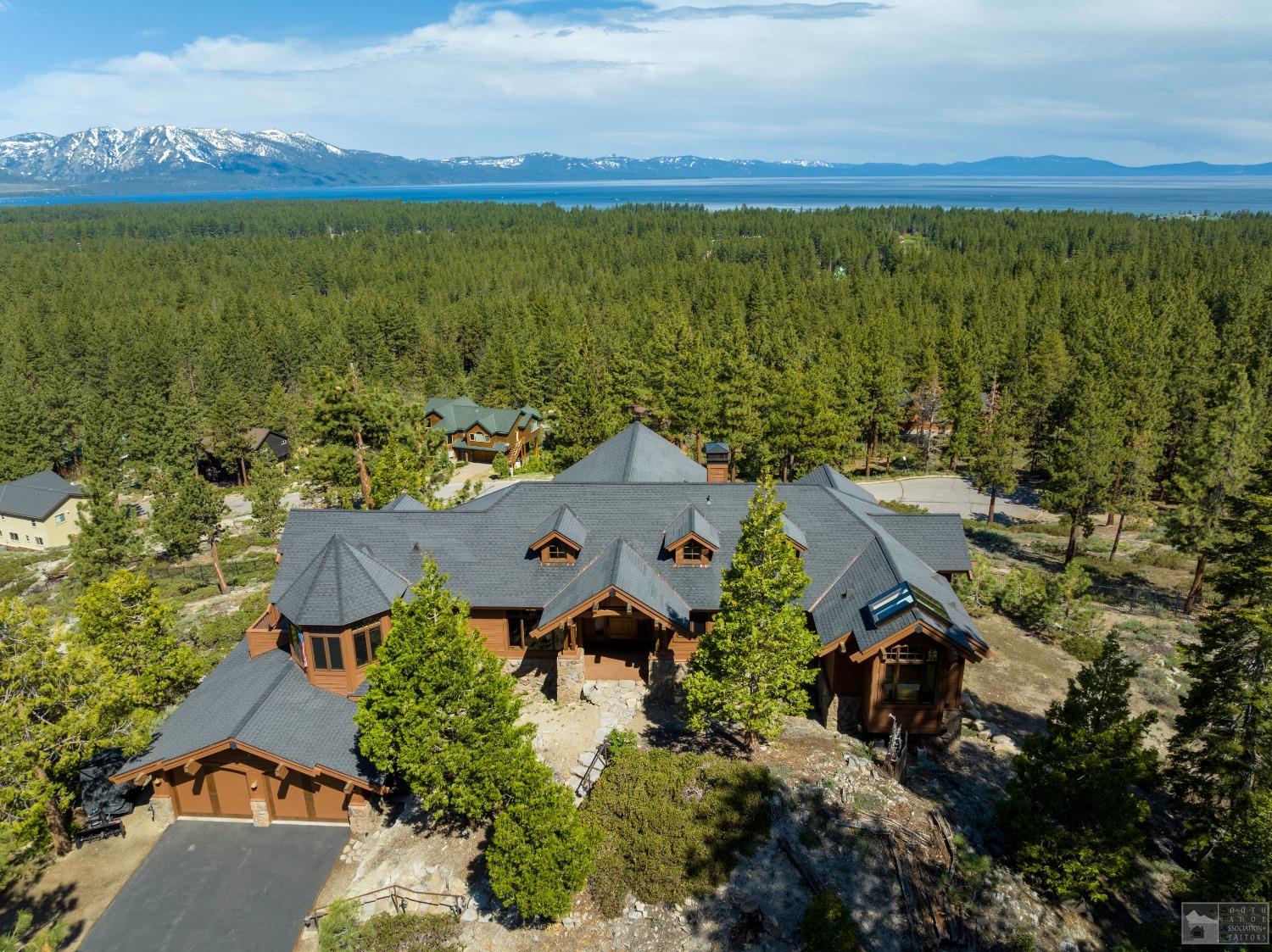 an aerial view of a house with a yard lake view and mountain view