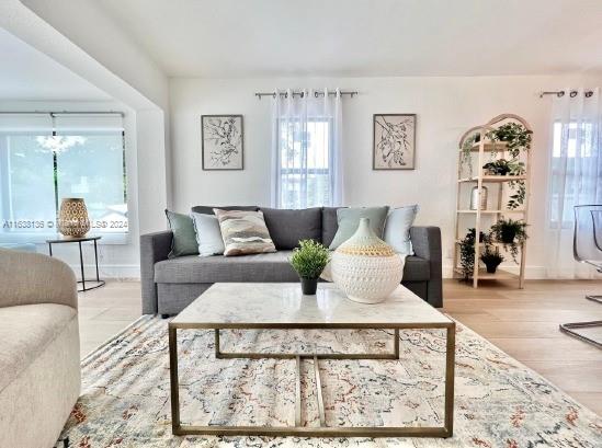 a living room with furniture and wooden floor