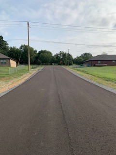 a view of a road with a big yard