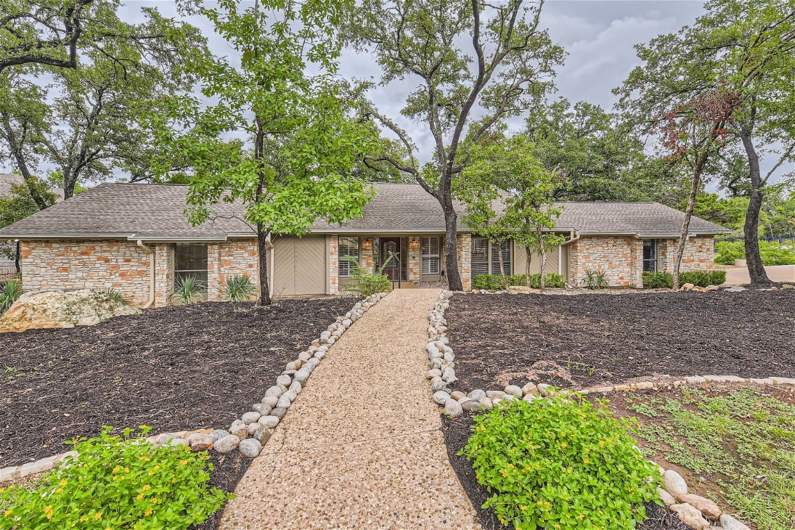 a front view of a house with a garden