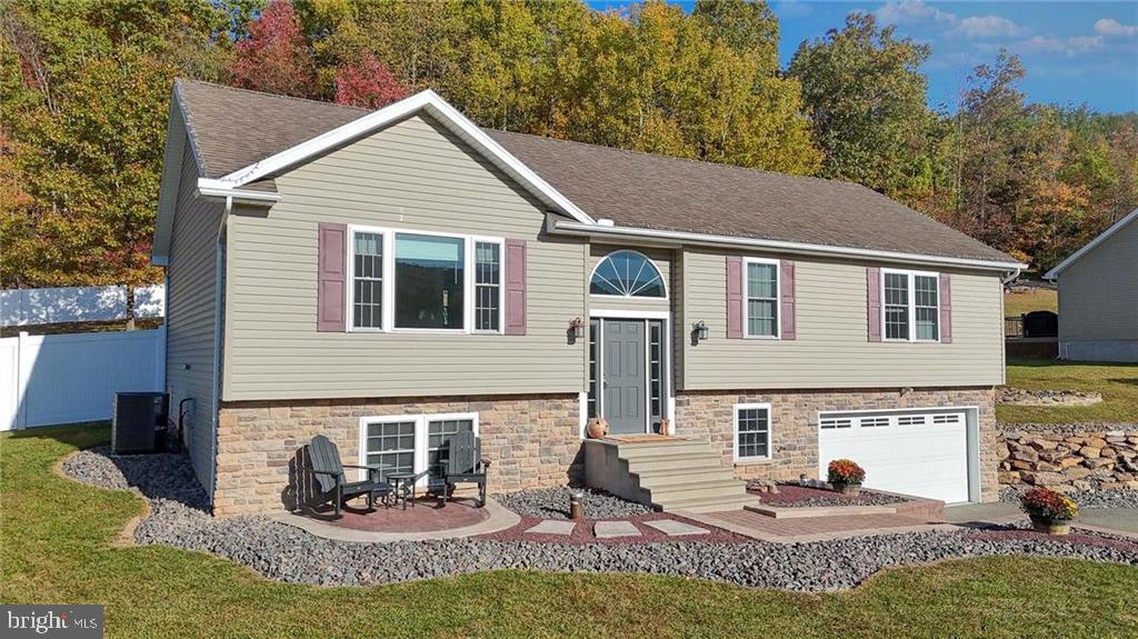 a view of a house with a yard and sitting area