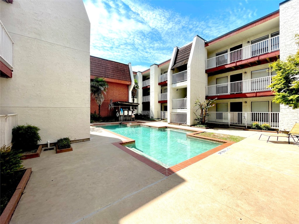 a view of swimming pool with building in the background