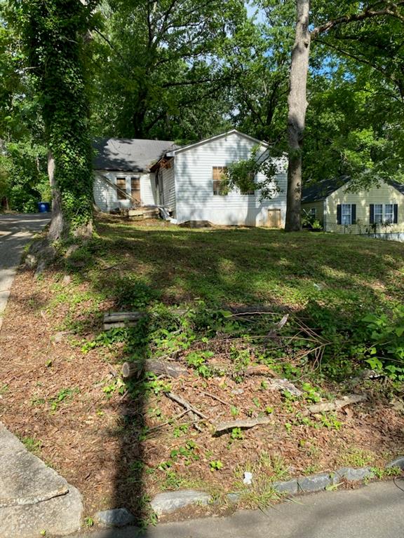 a view of house with yard