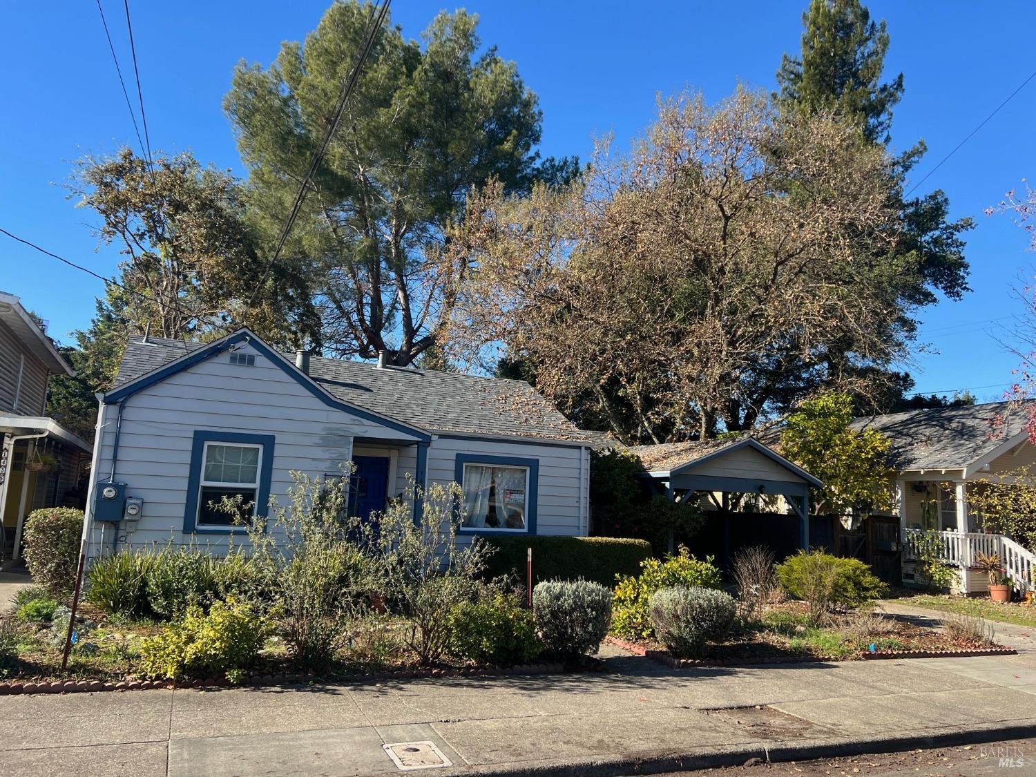 a front view of a house with a garden