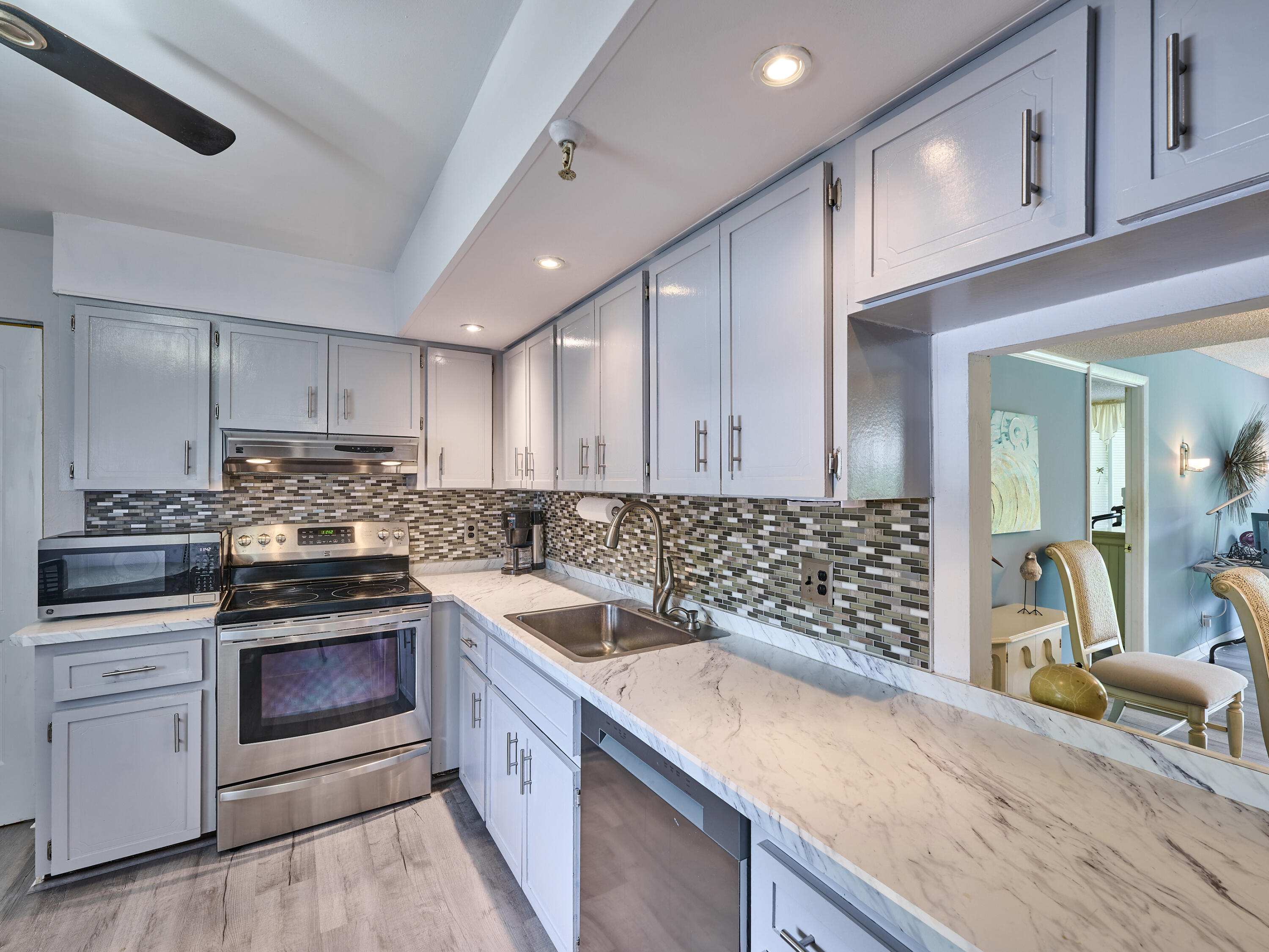 a kitchen with stainless steel appliances granite countertop a stove and a sink