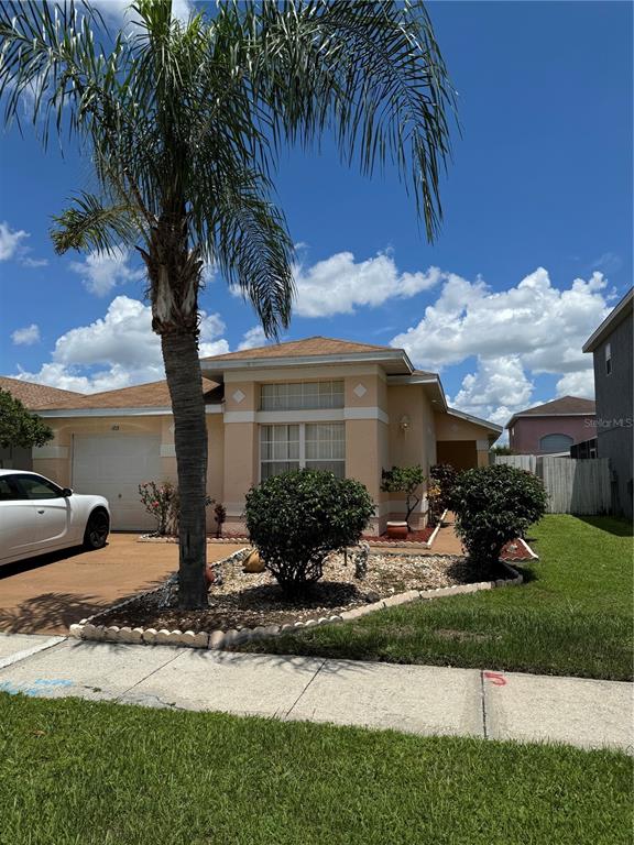 a front view of a house with garden and patio