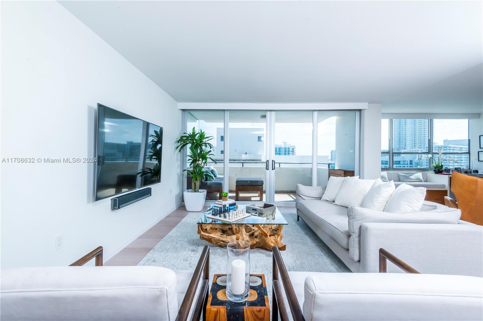 a living room with furniture and a flat screen tv