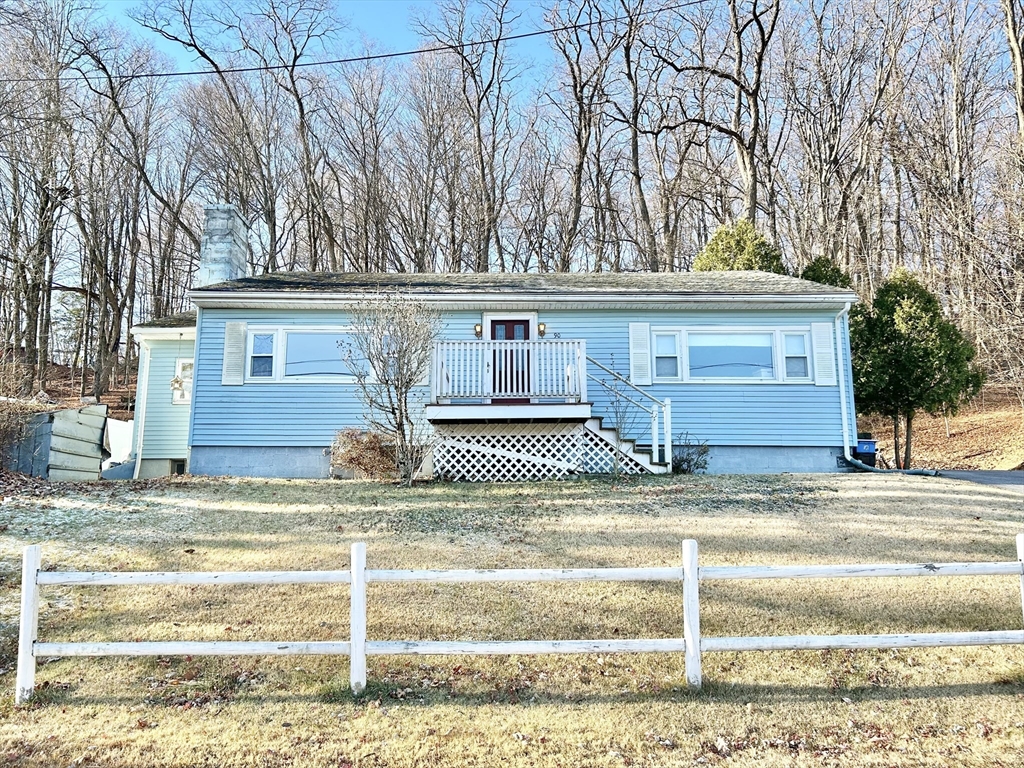 a view of a house with a snow and a tree