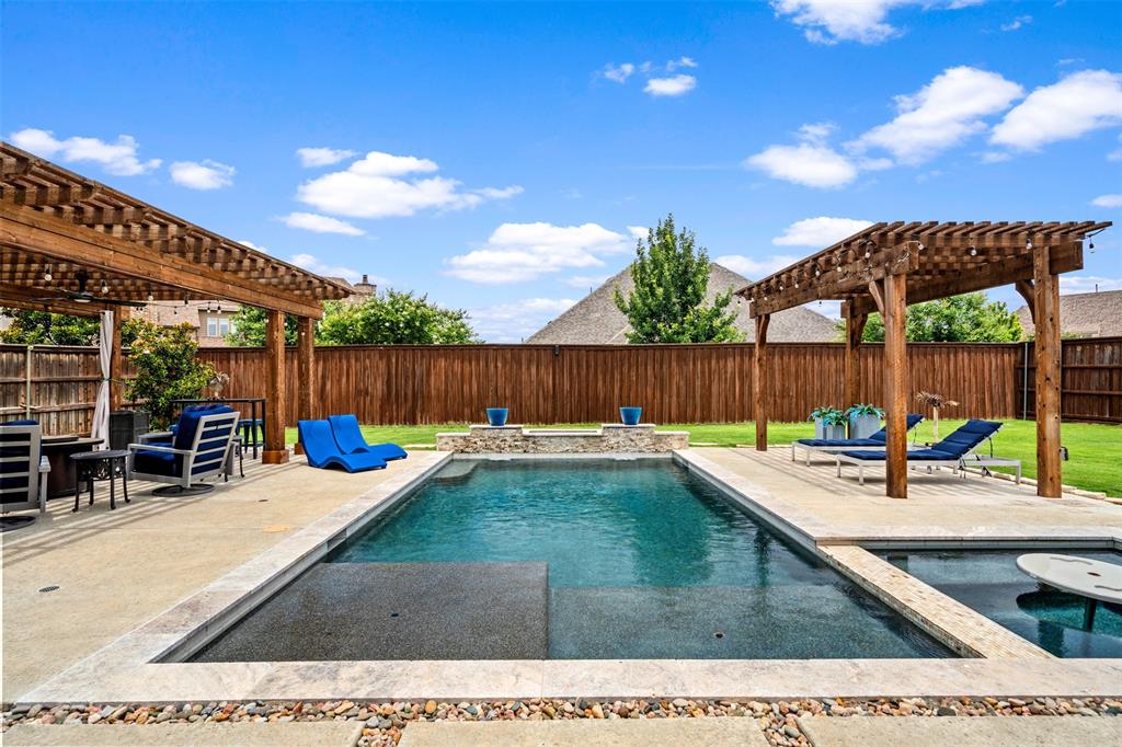 a view of a backyard with a patio and outdoor seating