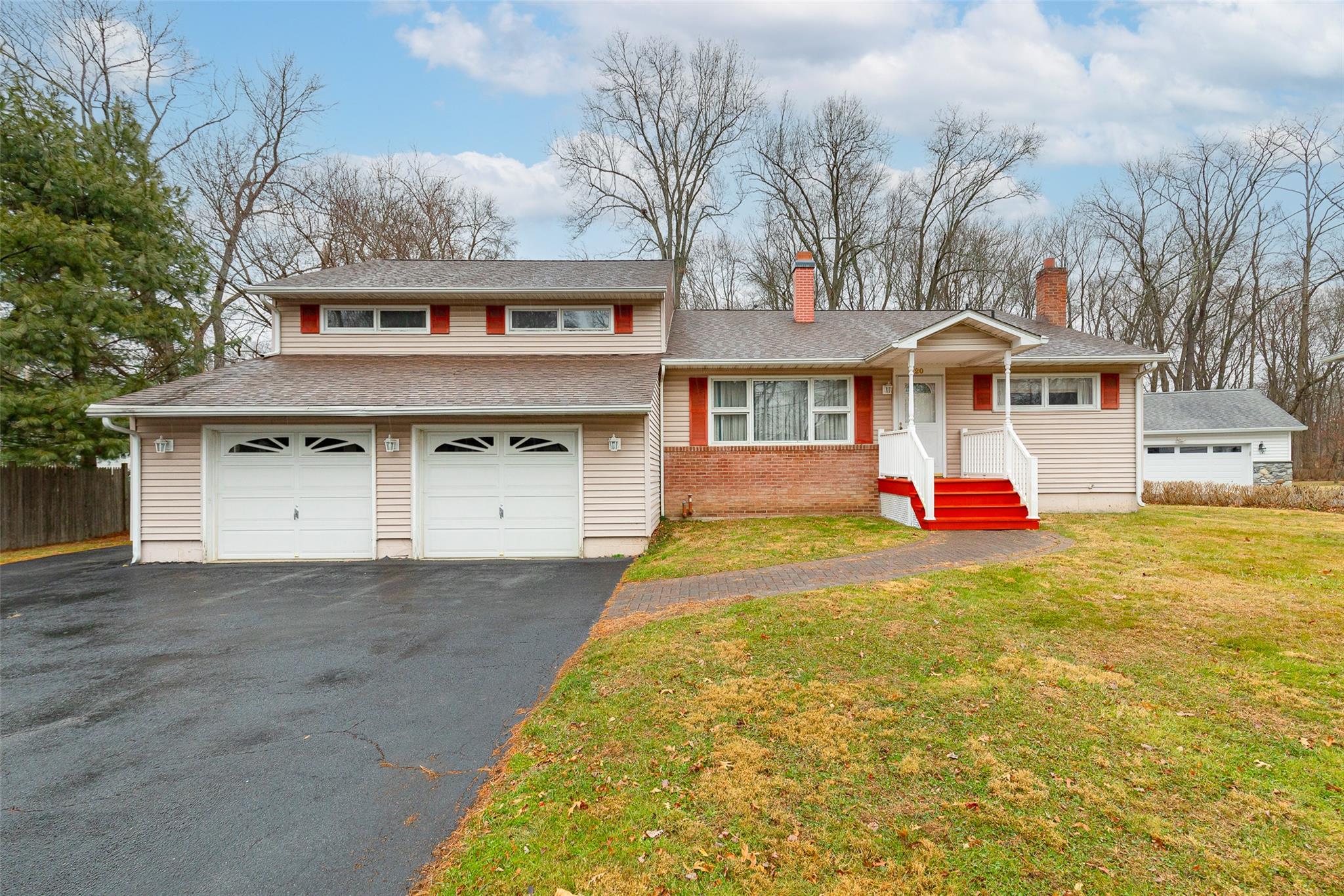 Split level home with a front yard and a garage