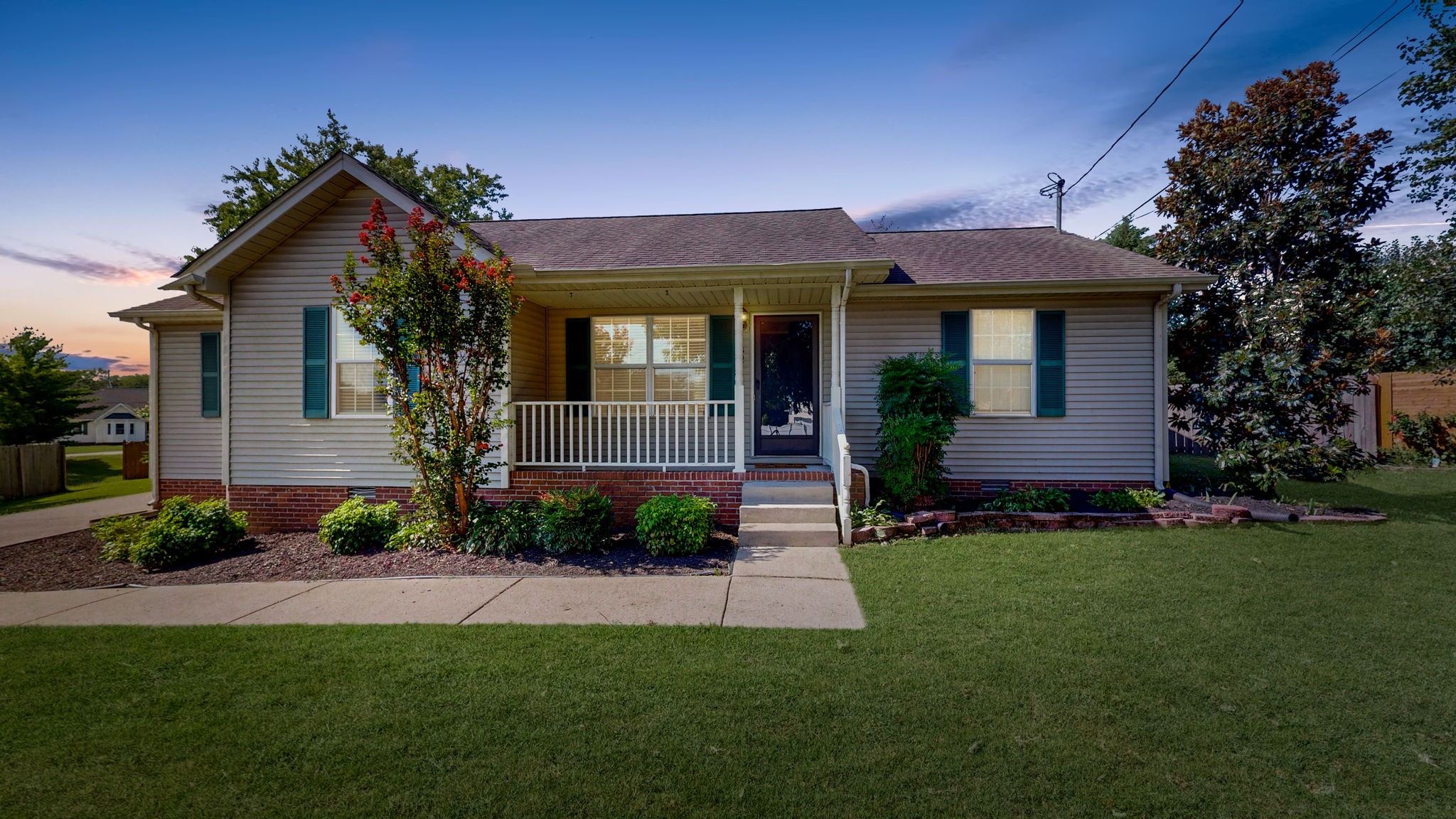 a front view of a house with a garden and plants