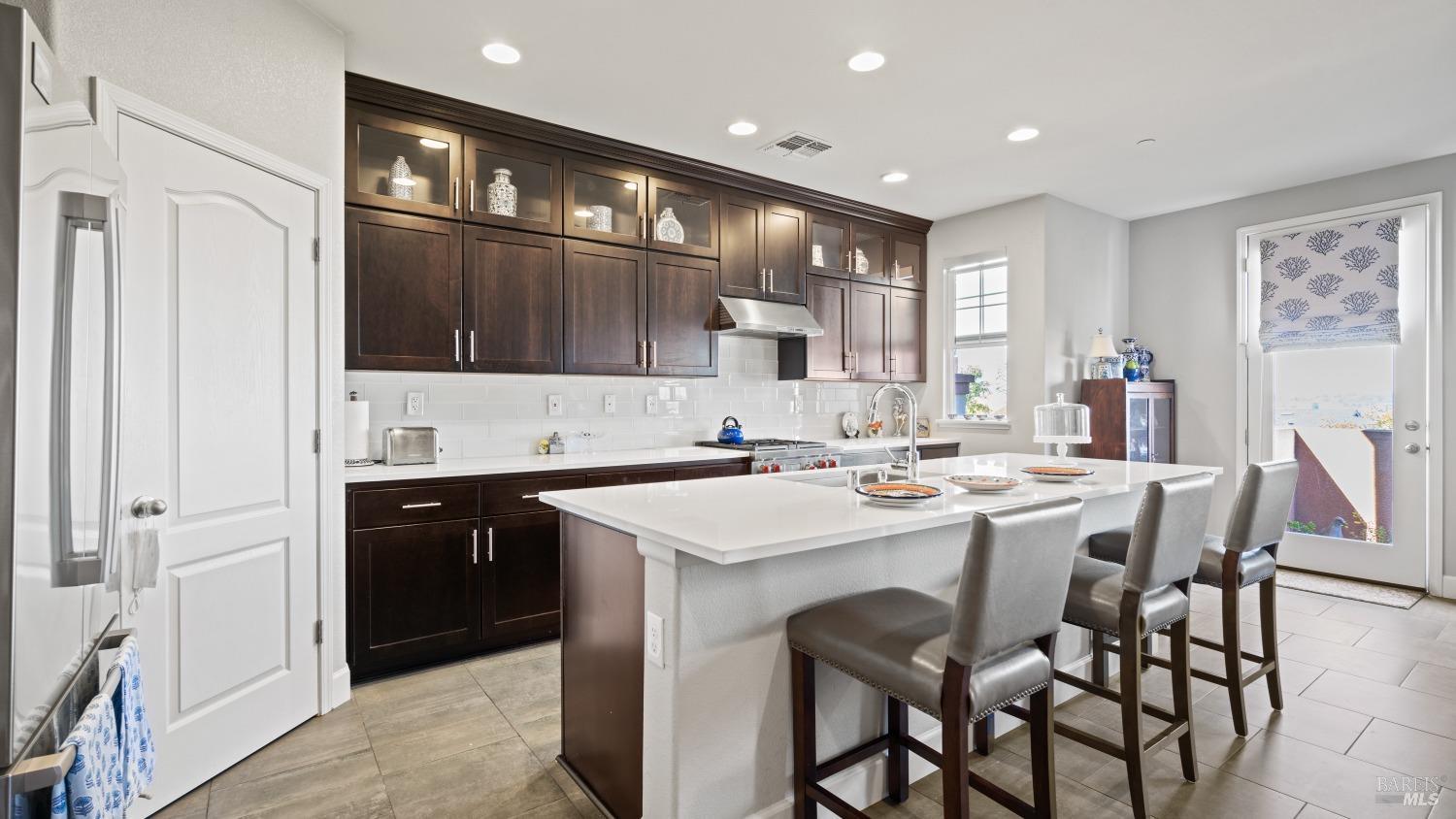 a kitchen with stainless steel appliances kitchen island granite countertop a sink and cabinets