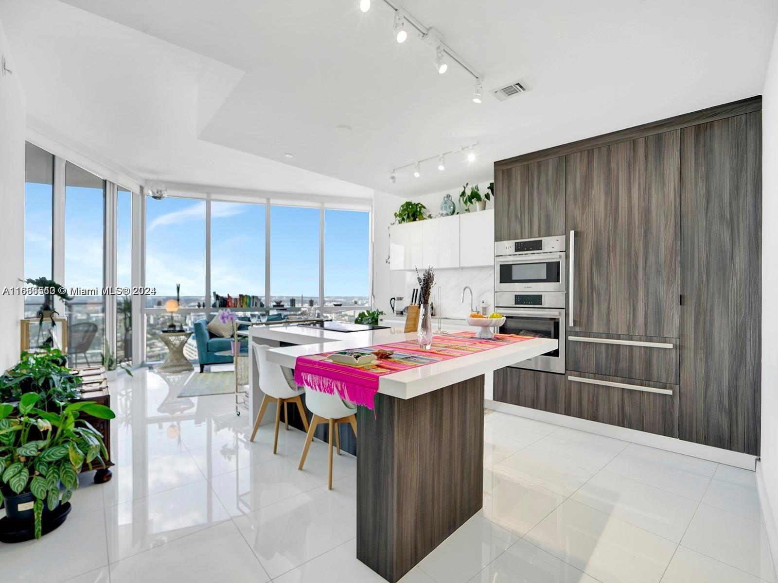 a kitchen with a table and chairs in it