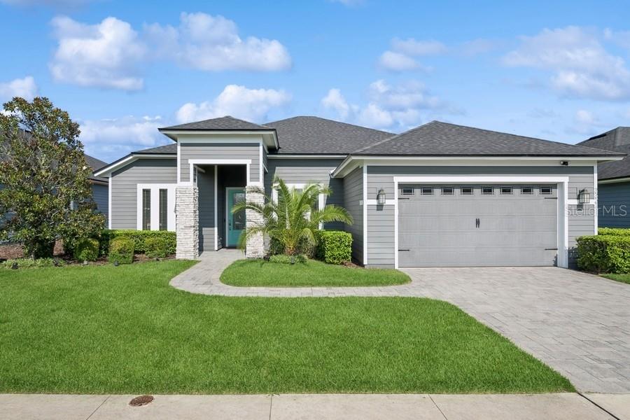 a front view of a house with a yard and garage