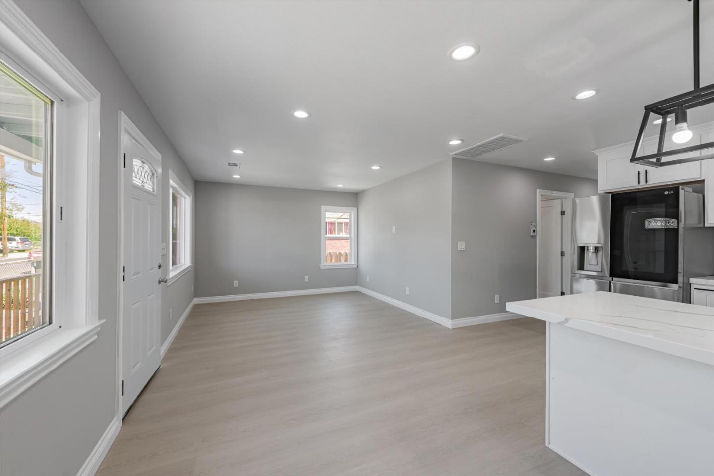 a view of hallway with kitchen island and living room