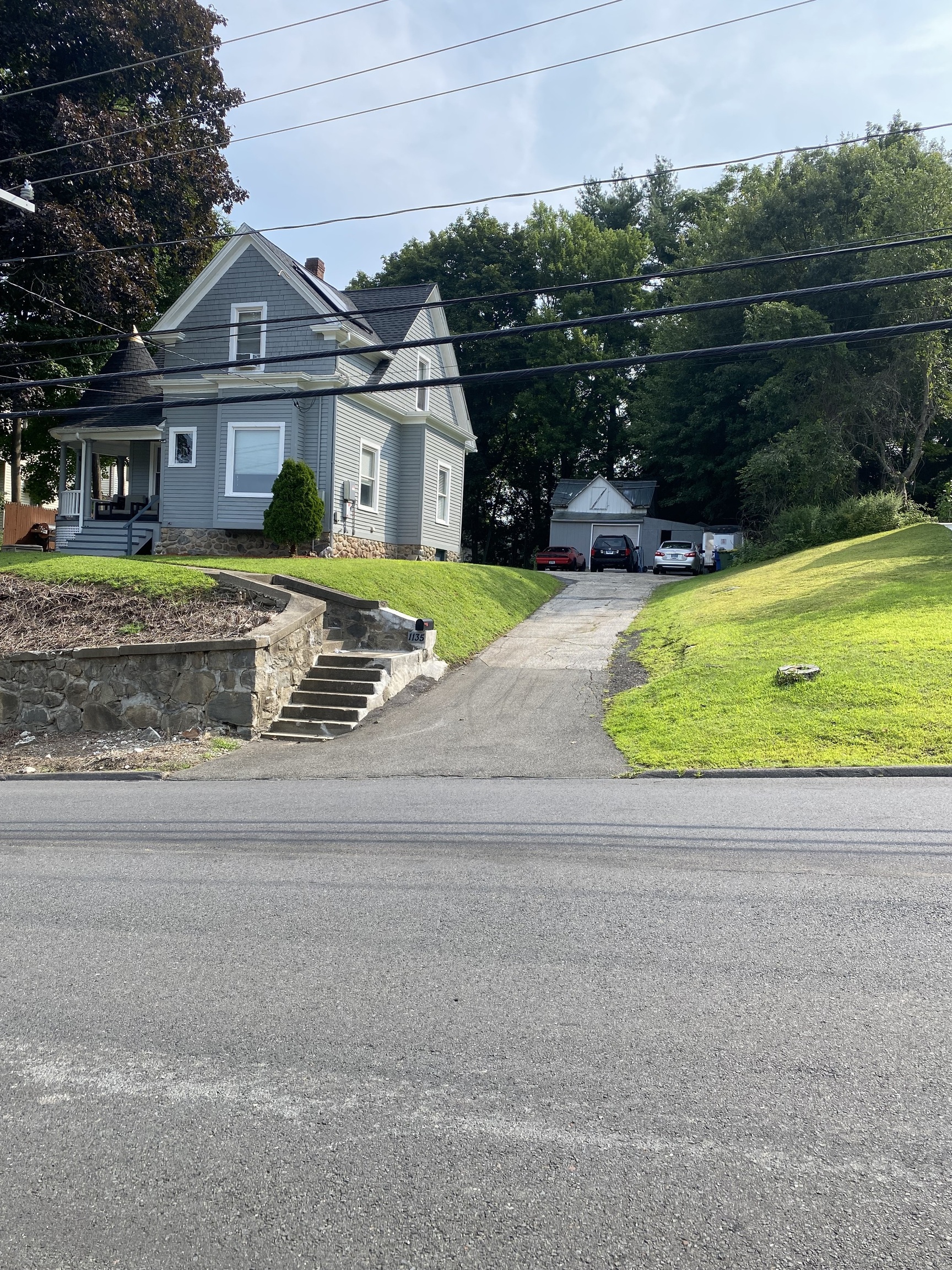 a front view of a house with a garden and yard