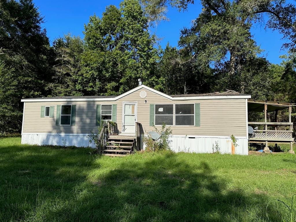 a front view of house with yard and outdoor seating