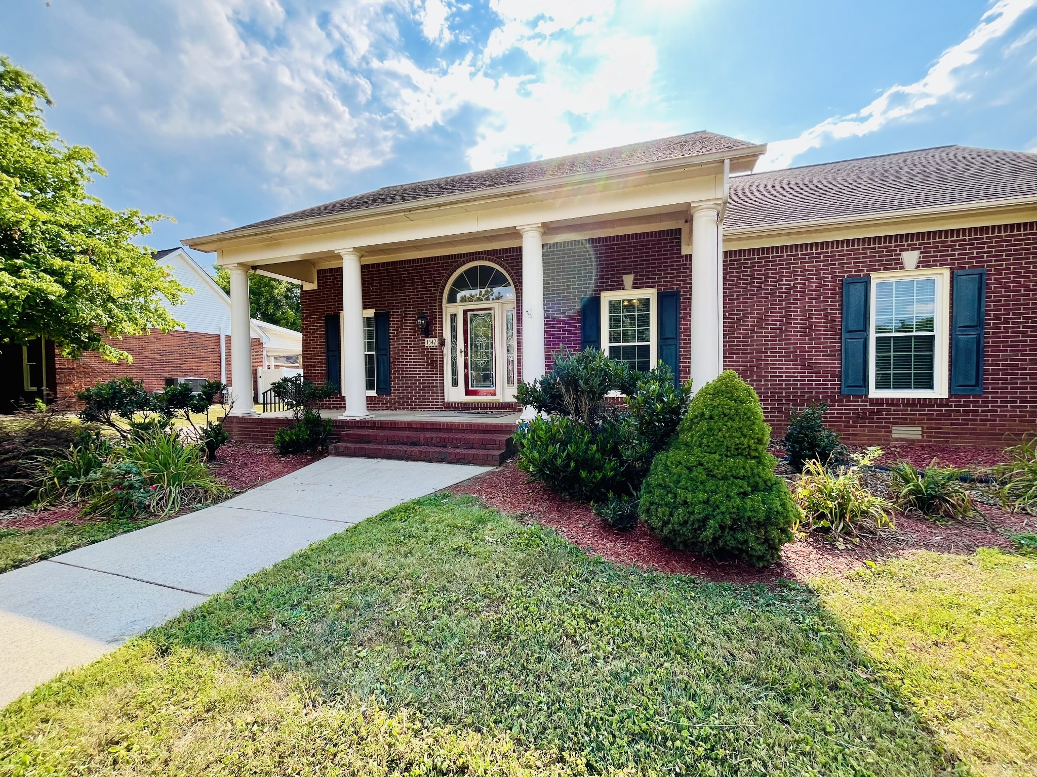 a front view of a house with garden