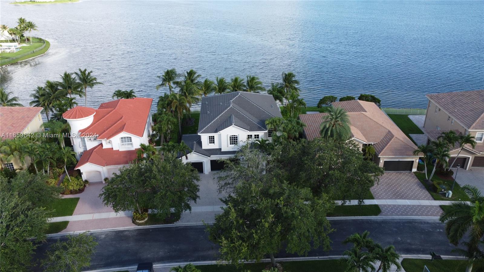 an aerial view of a house with outdoor space and a garden