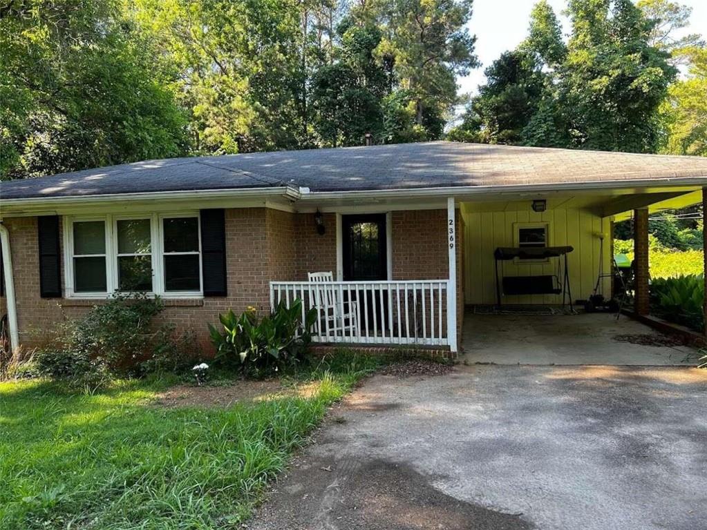 a view of a house with a porch and furniture