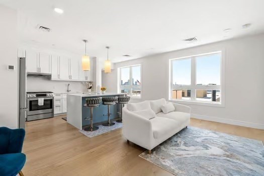 a living room with furniture and kitchen view