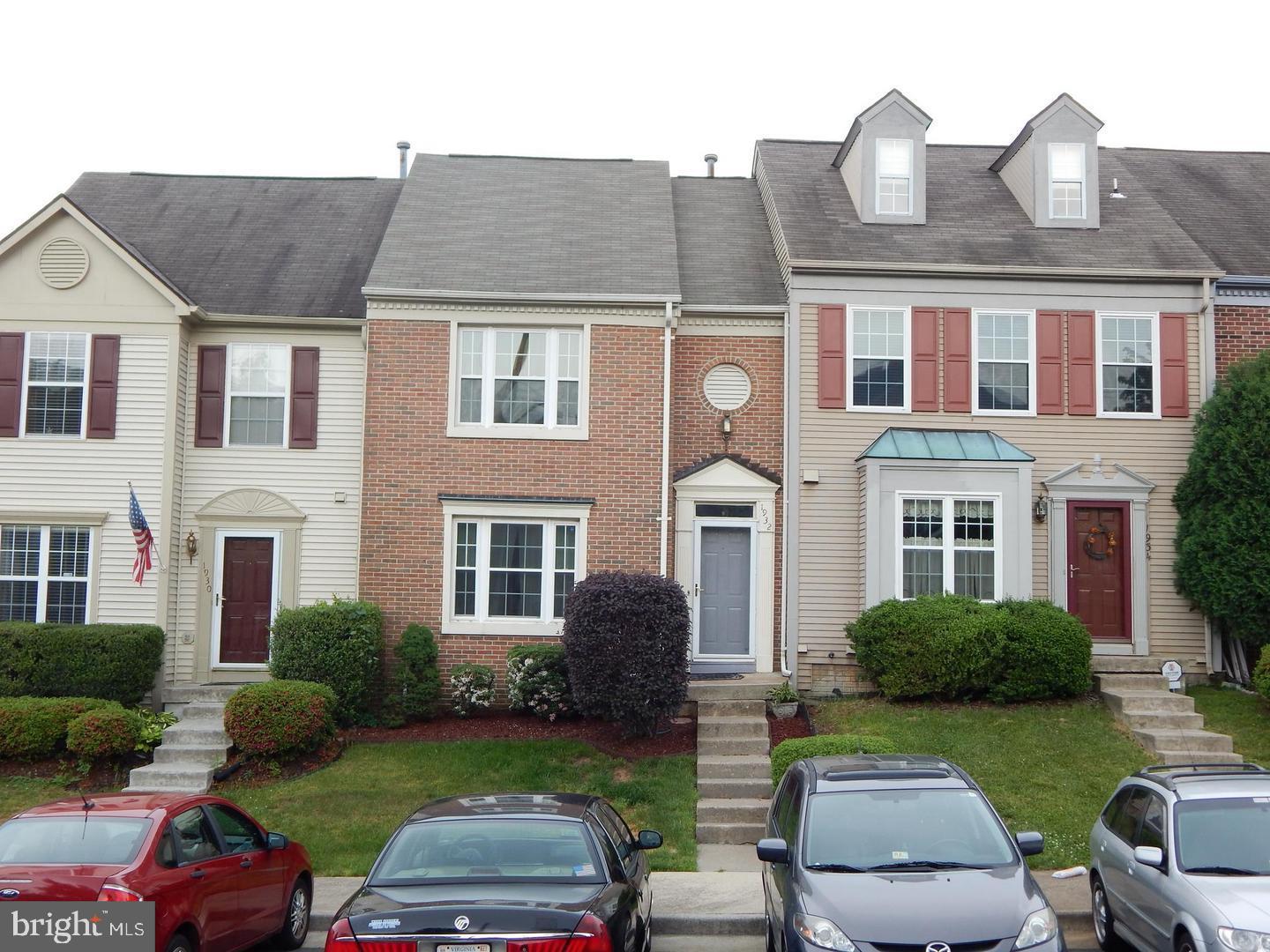 a front view of a house with garden and yard