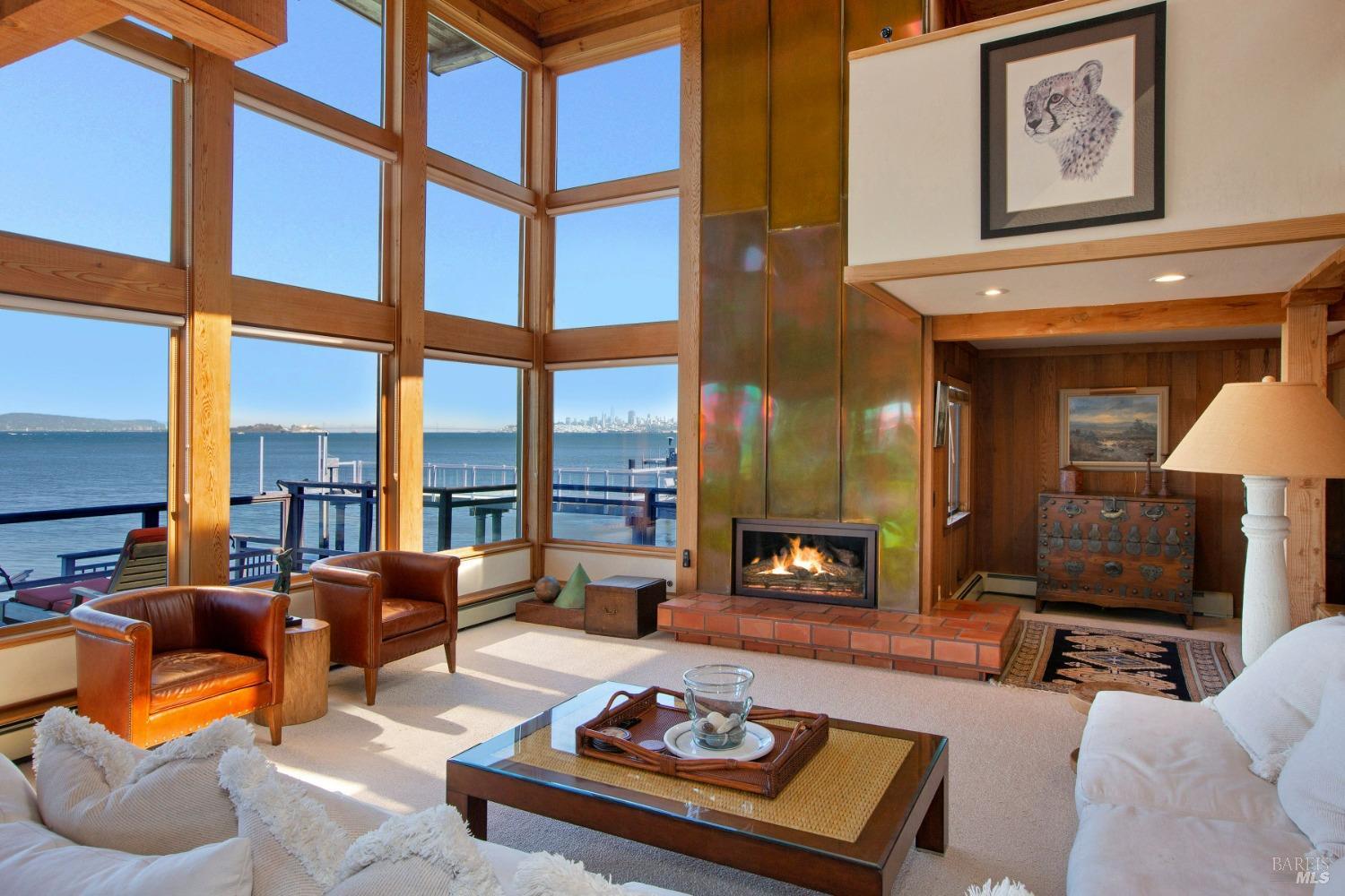 a living room with furniture a fireplace and a large window