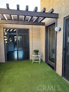 Patio with main entrance to the home and secondary entrance to the bedroom.