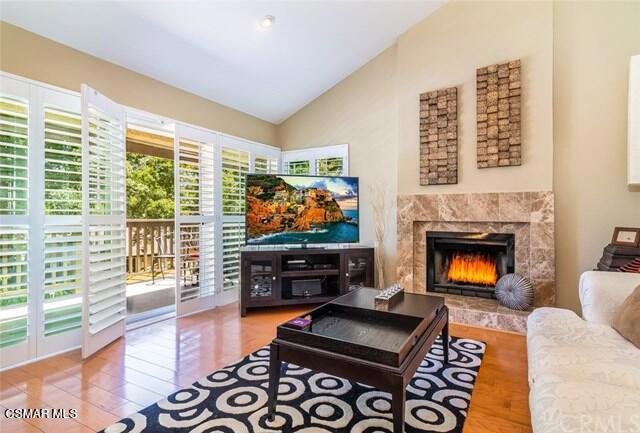 a living room with furniture a flat screen tv and a fireplace