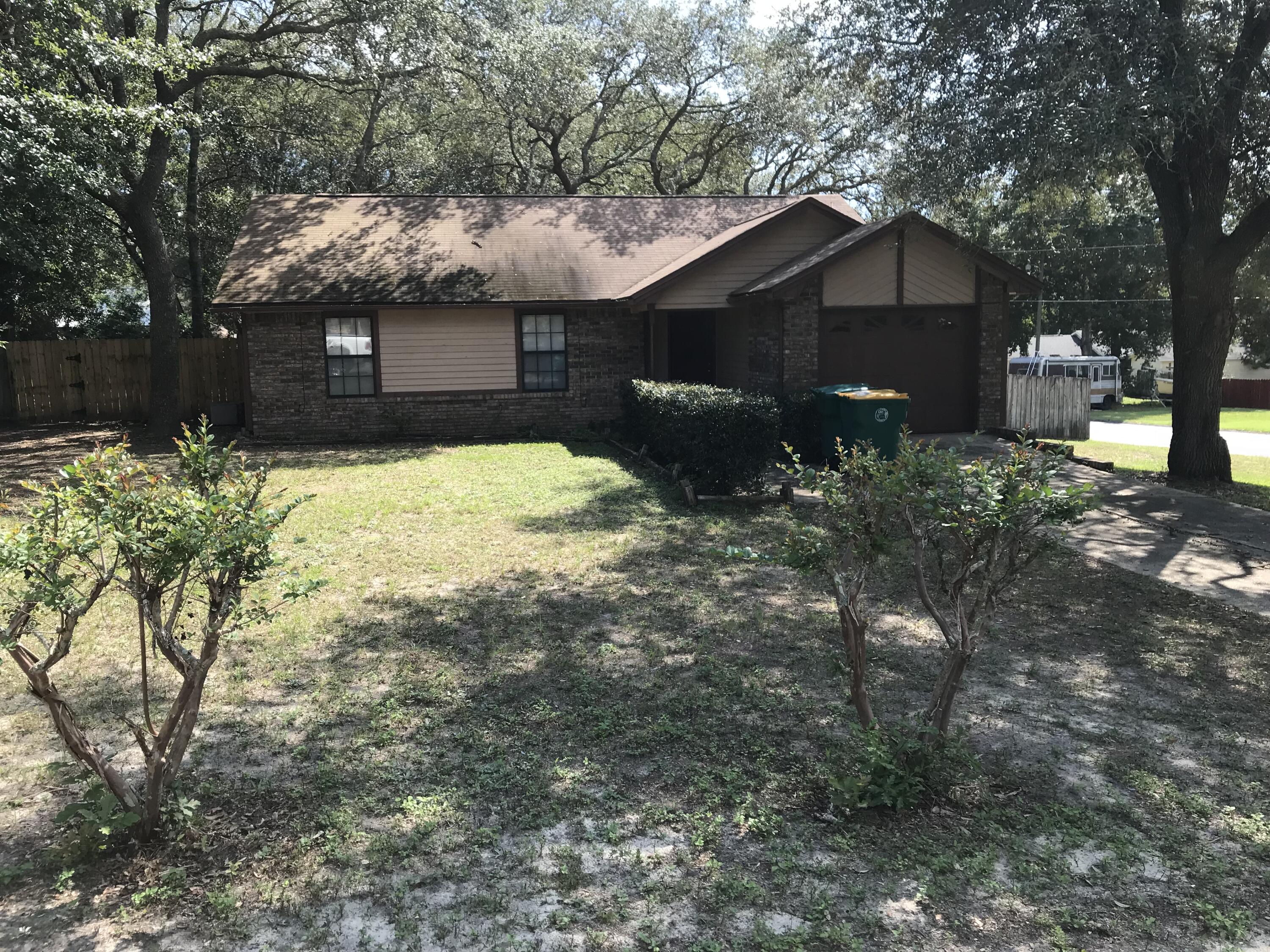 a front view of house with yard and trees