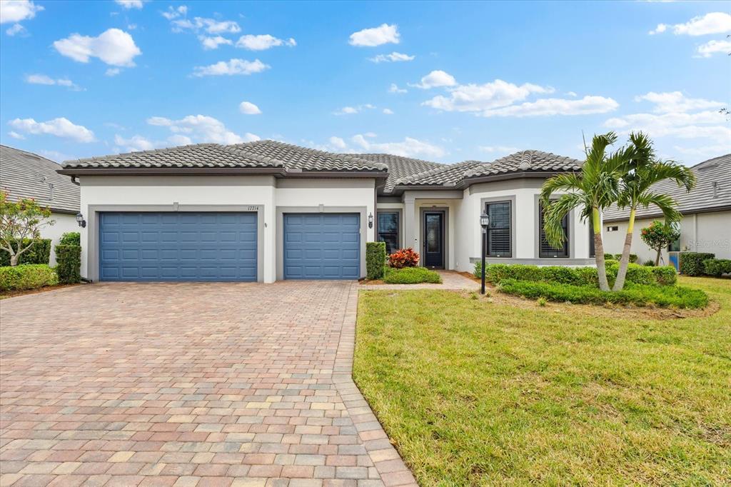 a front view of a house with a yard and garage