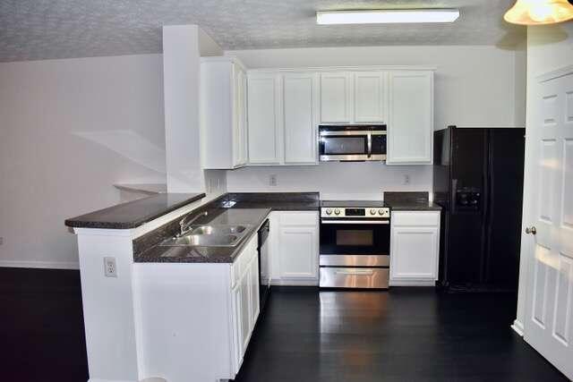 a kitchen with a stove and a refrigerator