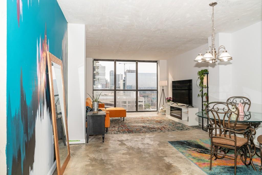 a view of a livingroom with furniture and a flat screen tv