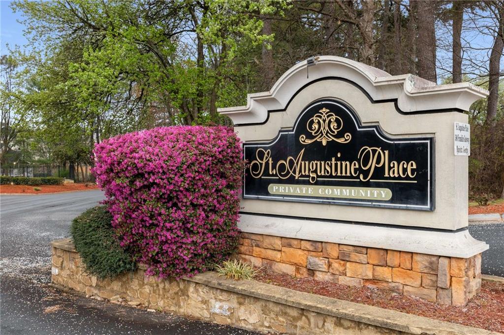 a view of sign board and a garden