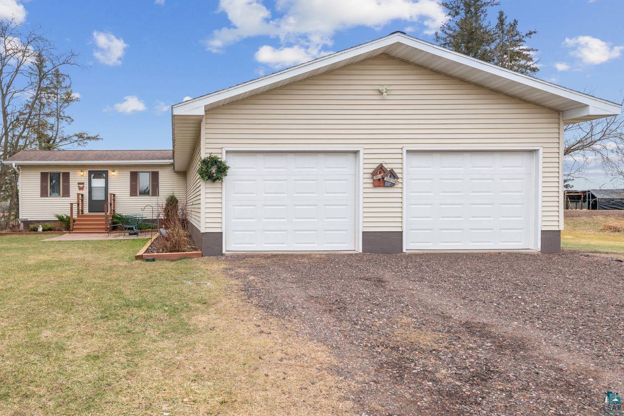 Ranch-style house with a front yard and a garage