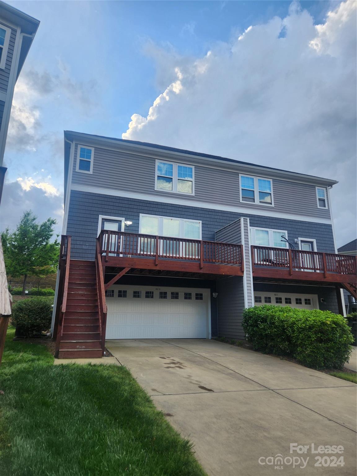 a view of house with a yard and deck