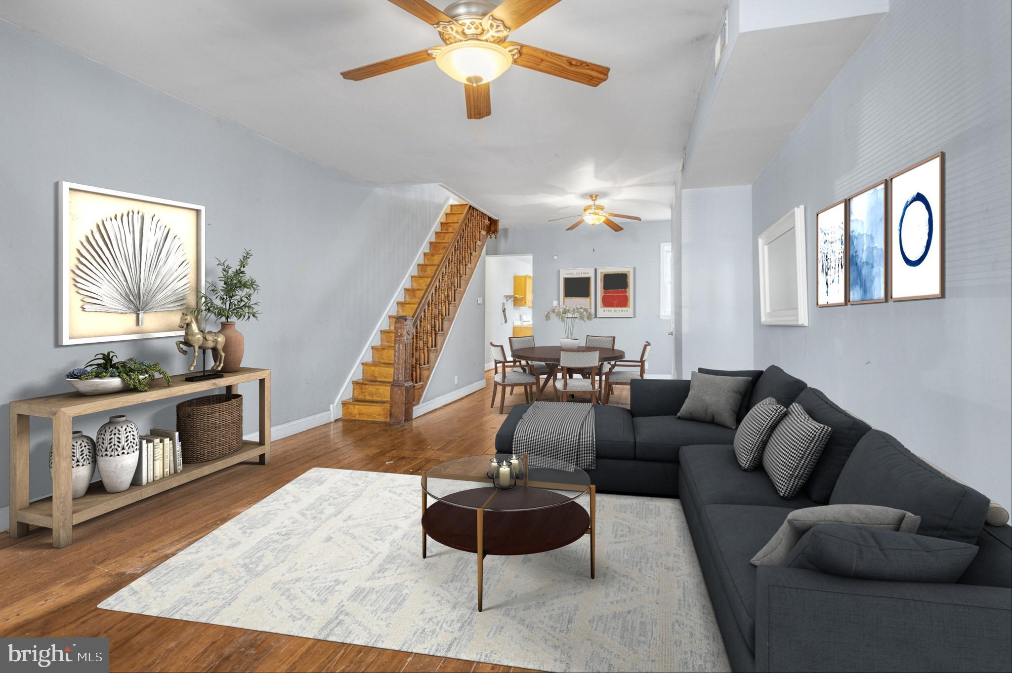 a living room with furniture and a wooden floor