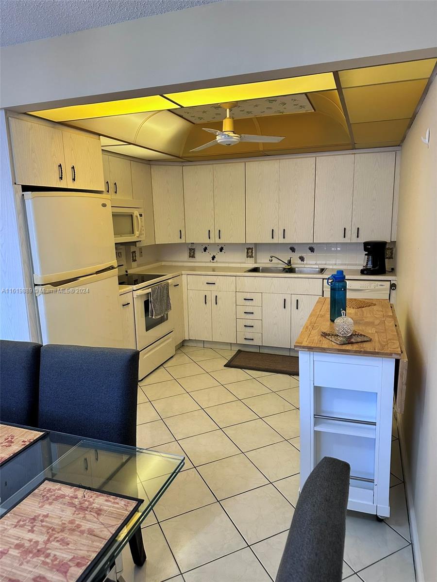 a kitchen with a sink appliances and cabinets