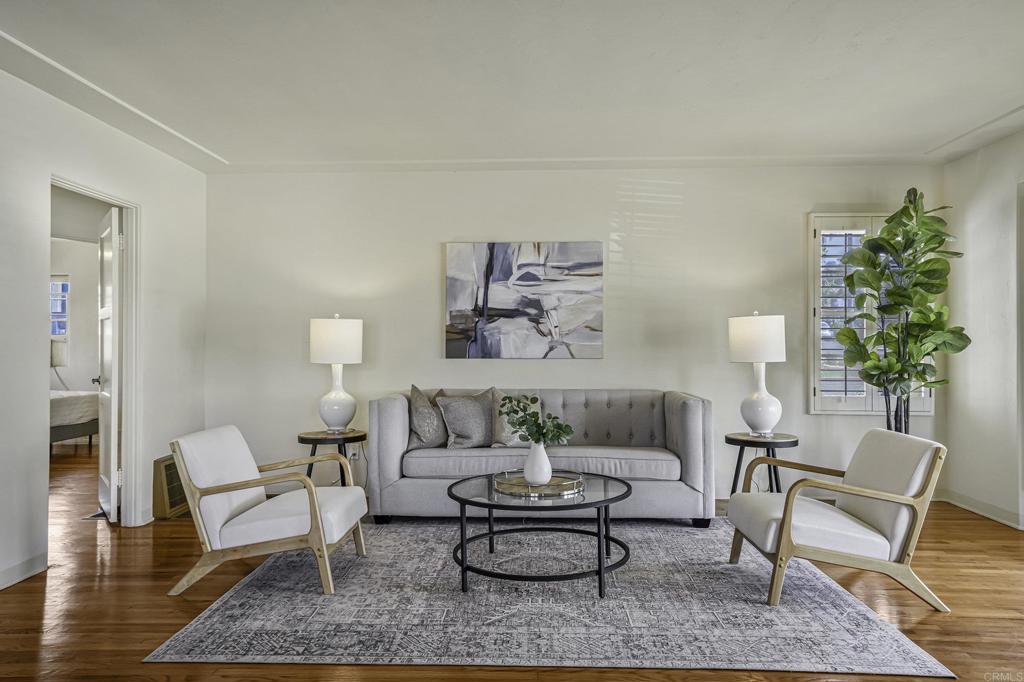 a living room with furniture and a potted plant